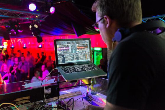 How do DJs leverage user-generated content to boost promotion?